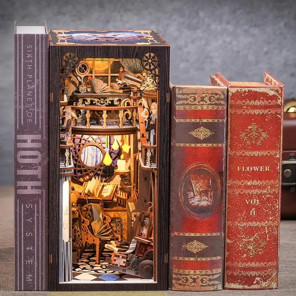 A miniature intricate mechanical device designed to look like it is inside a book, with visible gears and cogs, placed next to two ornate, vintage-style books.