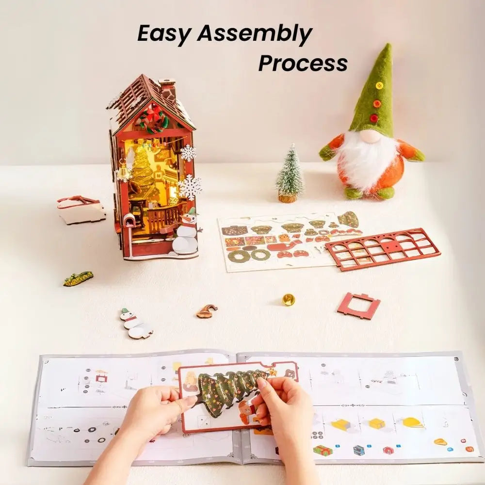 Assembly process of a decorative house with instructions and parts on a white surface.