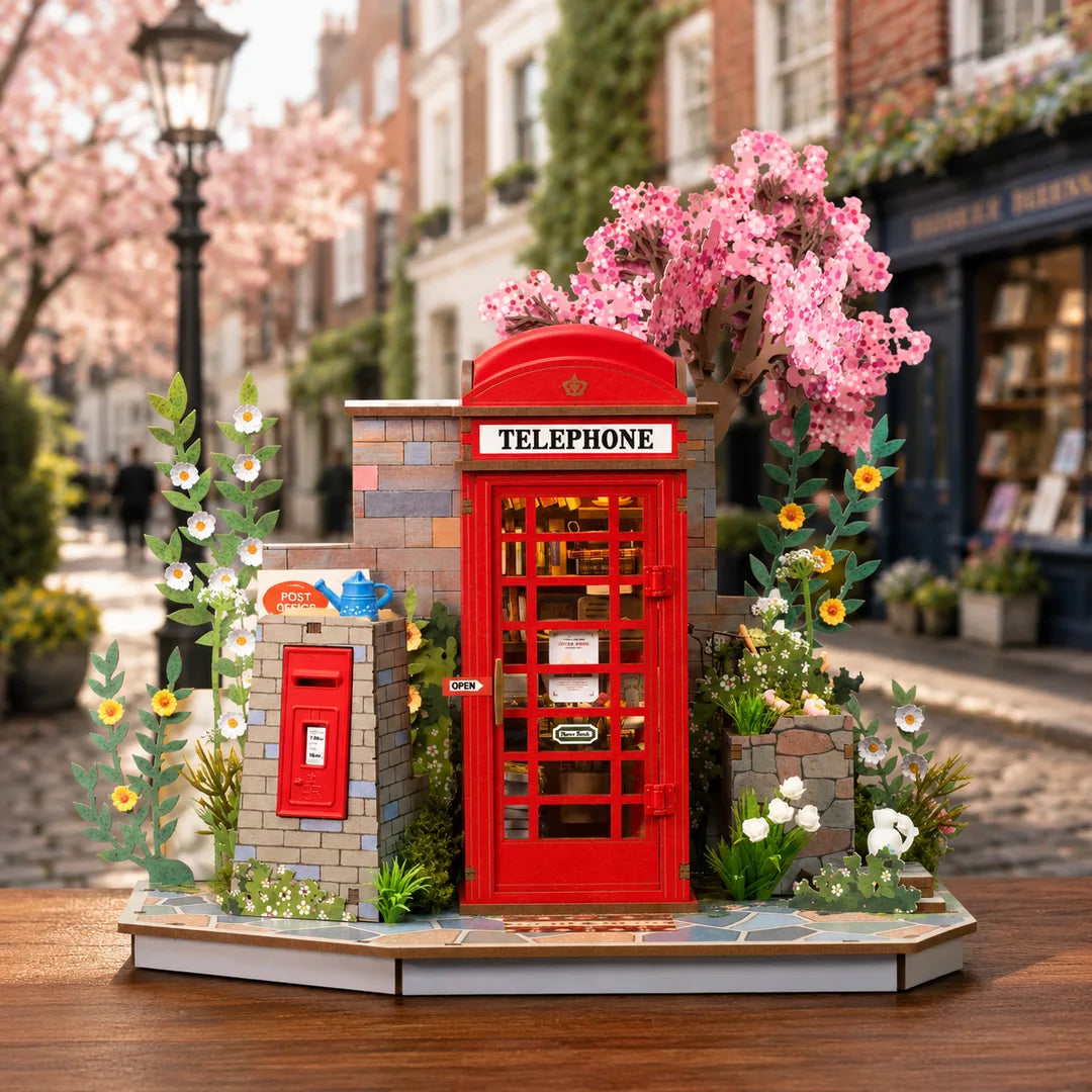 Front view of the Blossom Corner DIY Book Nook miniature with blooming cherry blossom background