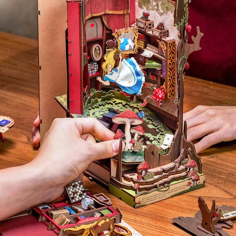 Hands assembling NookTales miniature book nook kit