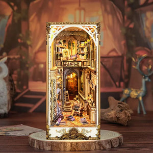 A detailed miniature model of a baroque-style room with intricate decorations and a golden frame, displayed on a wooden stand.