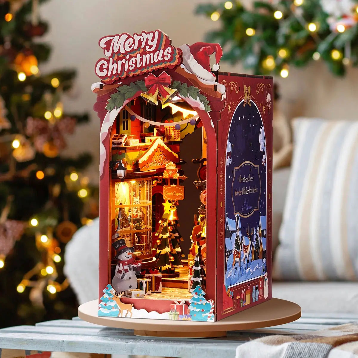 Decorative Christmas scene with a 'Merry Christmas' sign, lights, and festive elements on a table.