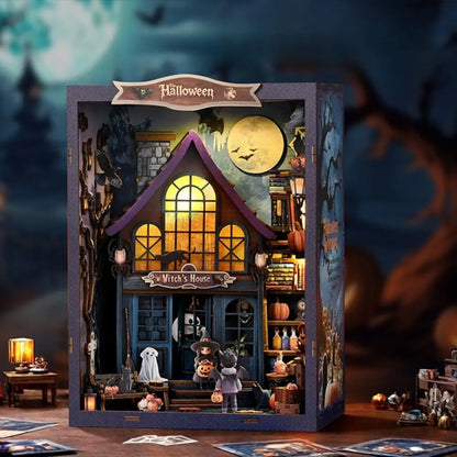 Halloween-themed dollhouse with a witch's house sign, surrounded by spooky decorations.